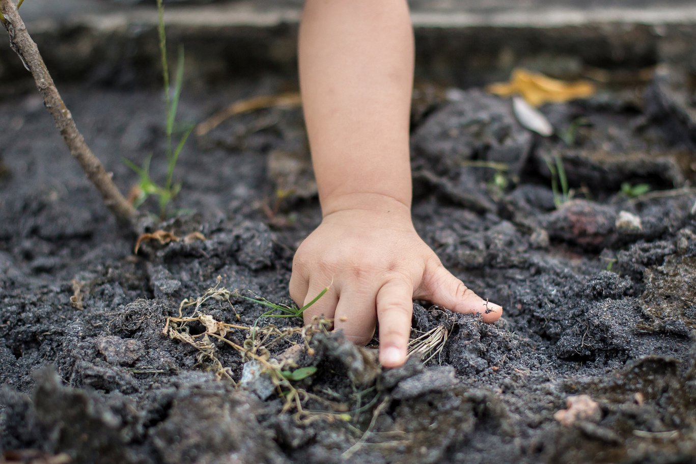 Asian children playing outside with dirty hands